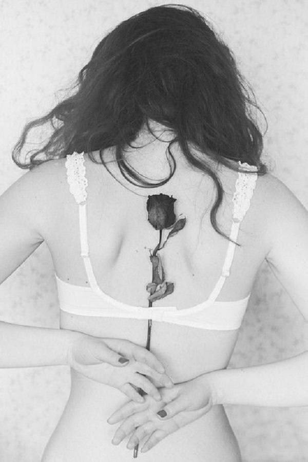 Black and gray rose tattoo in the center of the back Tattoo on skin