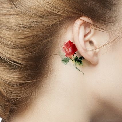 Tiny Bright Colored Rose Tattoo Idea Behind A Girls Ear Tattoo on skin