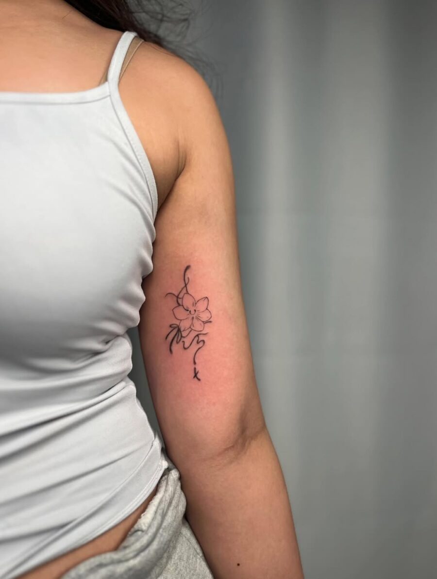 Delicate sampaguita tattoo in elegant black ink Tattoo on skin
