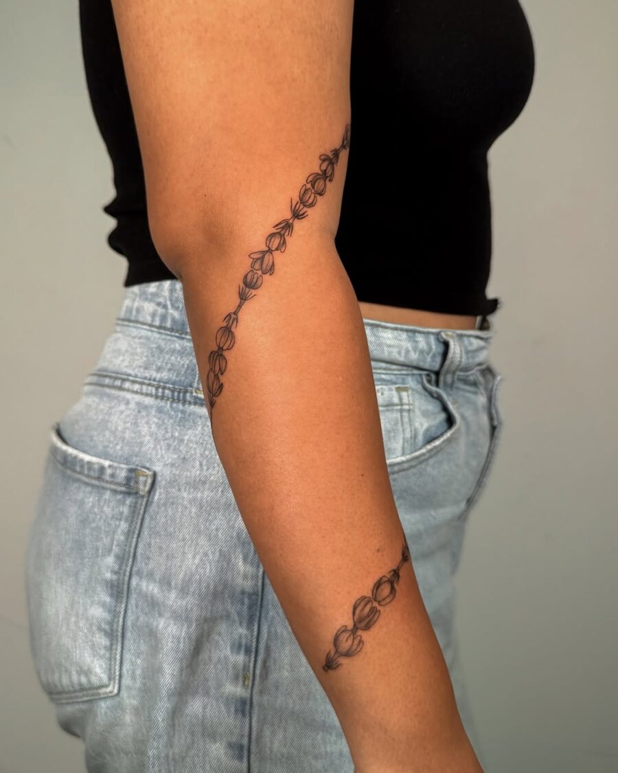 Elegant sampaguita tattoo gracefully wraps around elbow Tattoo on skin