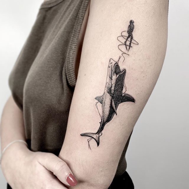 Artistic depiction of a shark and fisherman tattoo Tattoo on skin