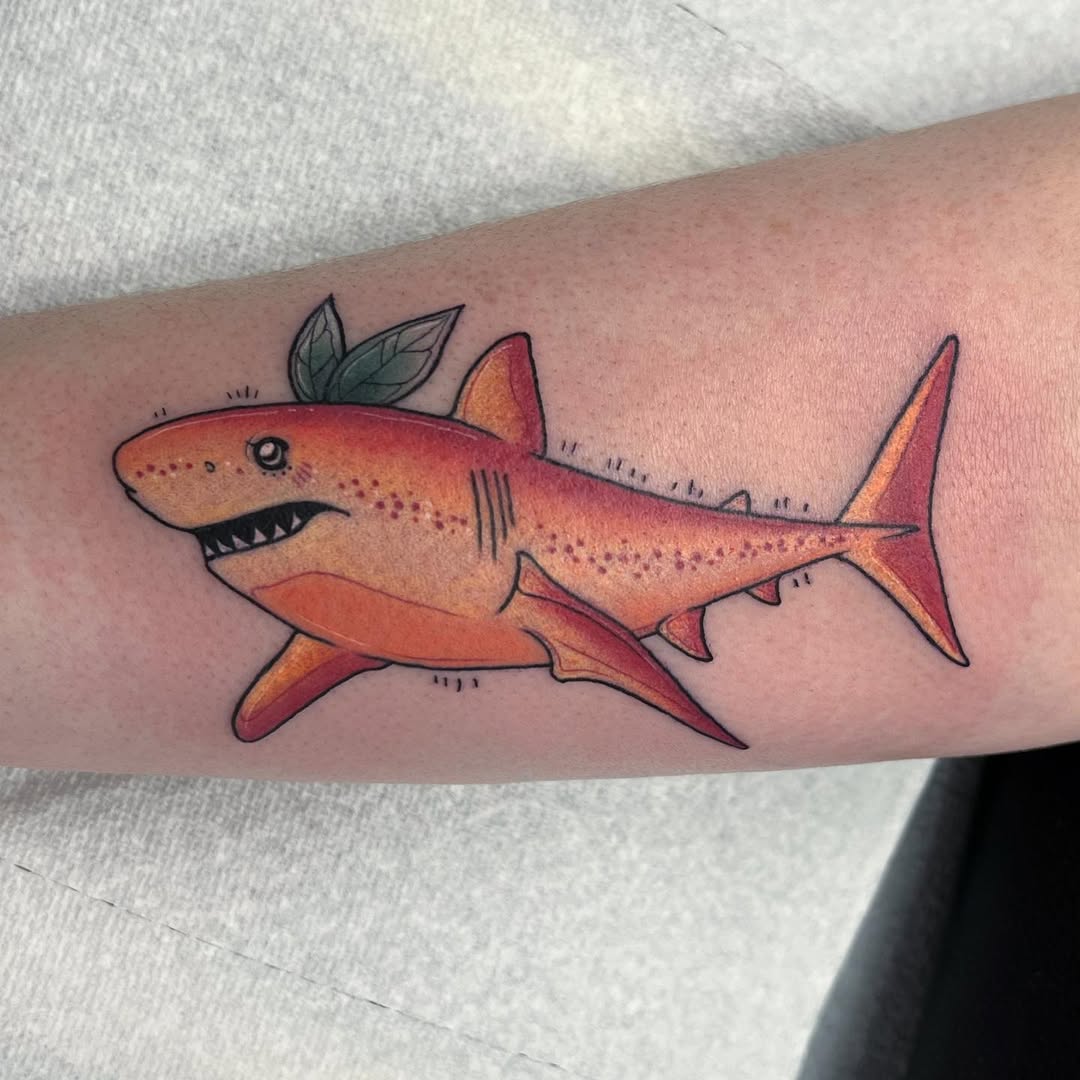 Playful shark tattoo with vibrant colors Tattoo on skin
