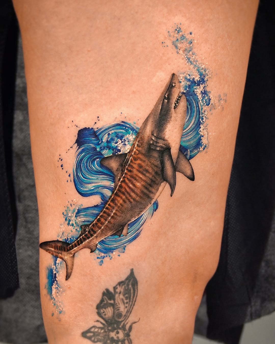 Stunning shark tattoo with dynamic water design Tattoo on skin