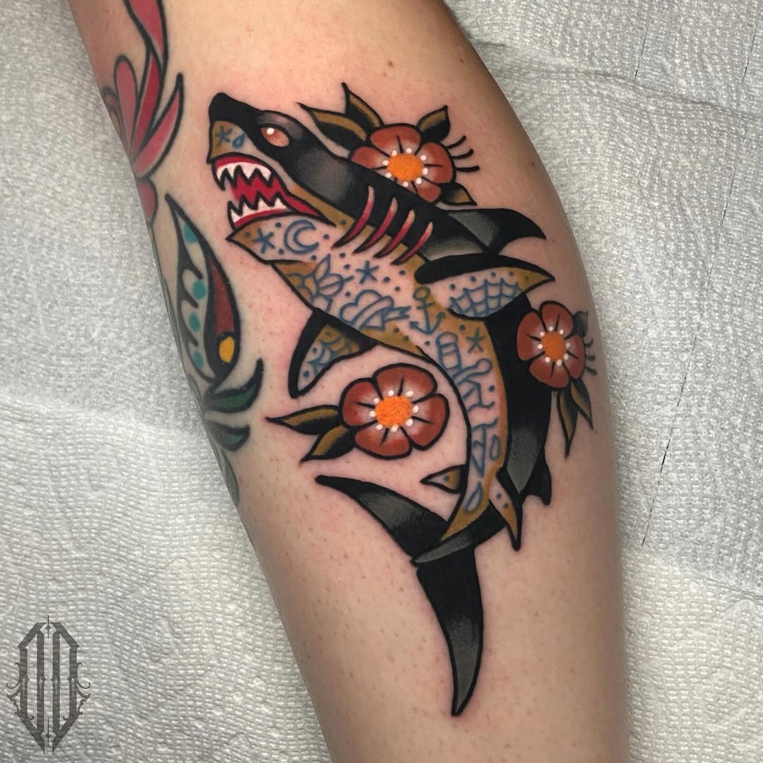 Vibrant shark tattoo adorned with floral elements Tattoo on skin