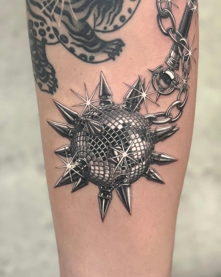 Edgy spiked tattoo with a silver sheen Tattoo on skin