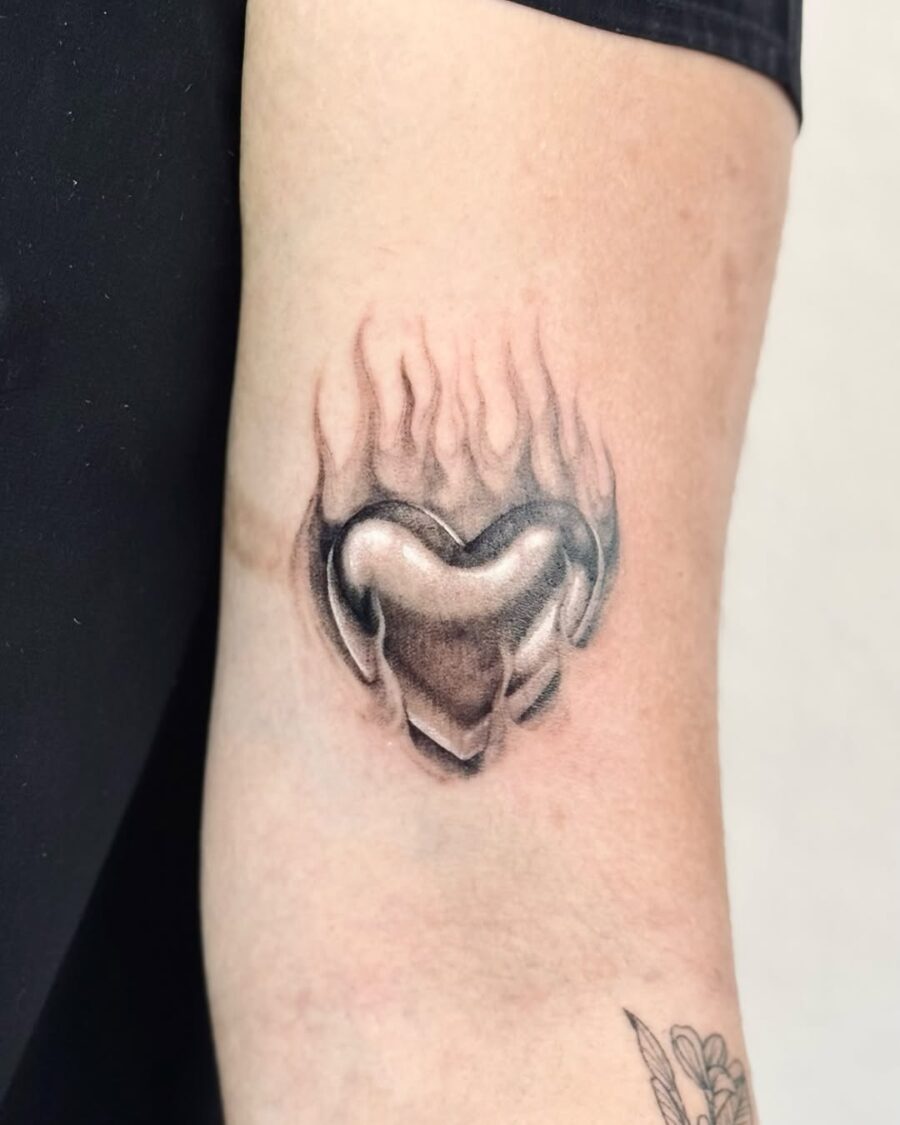 Elegant heart tattoo with flames design Tattoo on skin