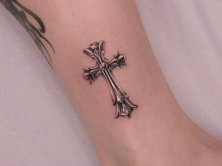 Elegant silver ink cross tattoo on wrist Tattoo on skin