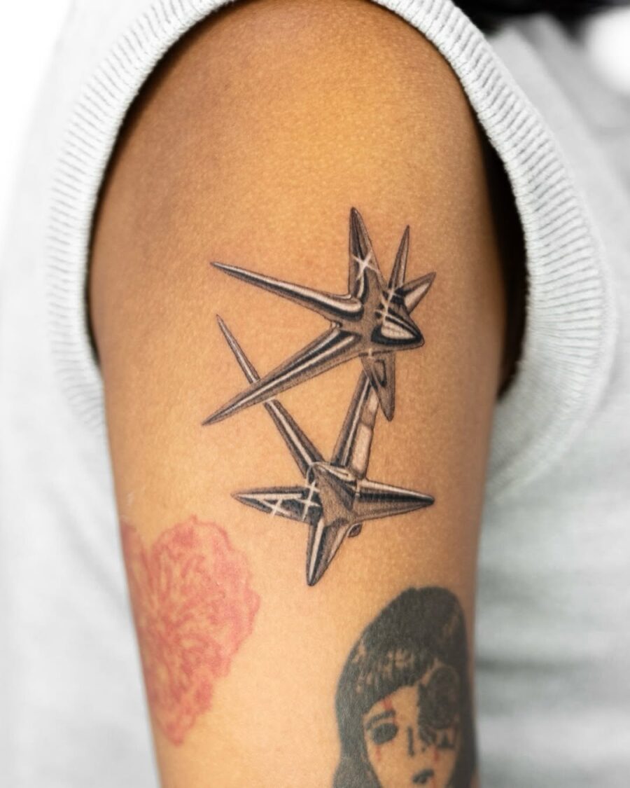 Sharp silver stars tattoo on forearm Tattoo on skin