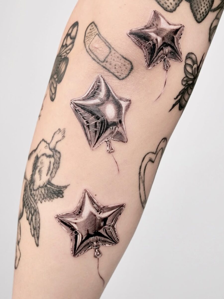 Stylish silver balloon tattoos on the arm Tattoo on skin