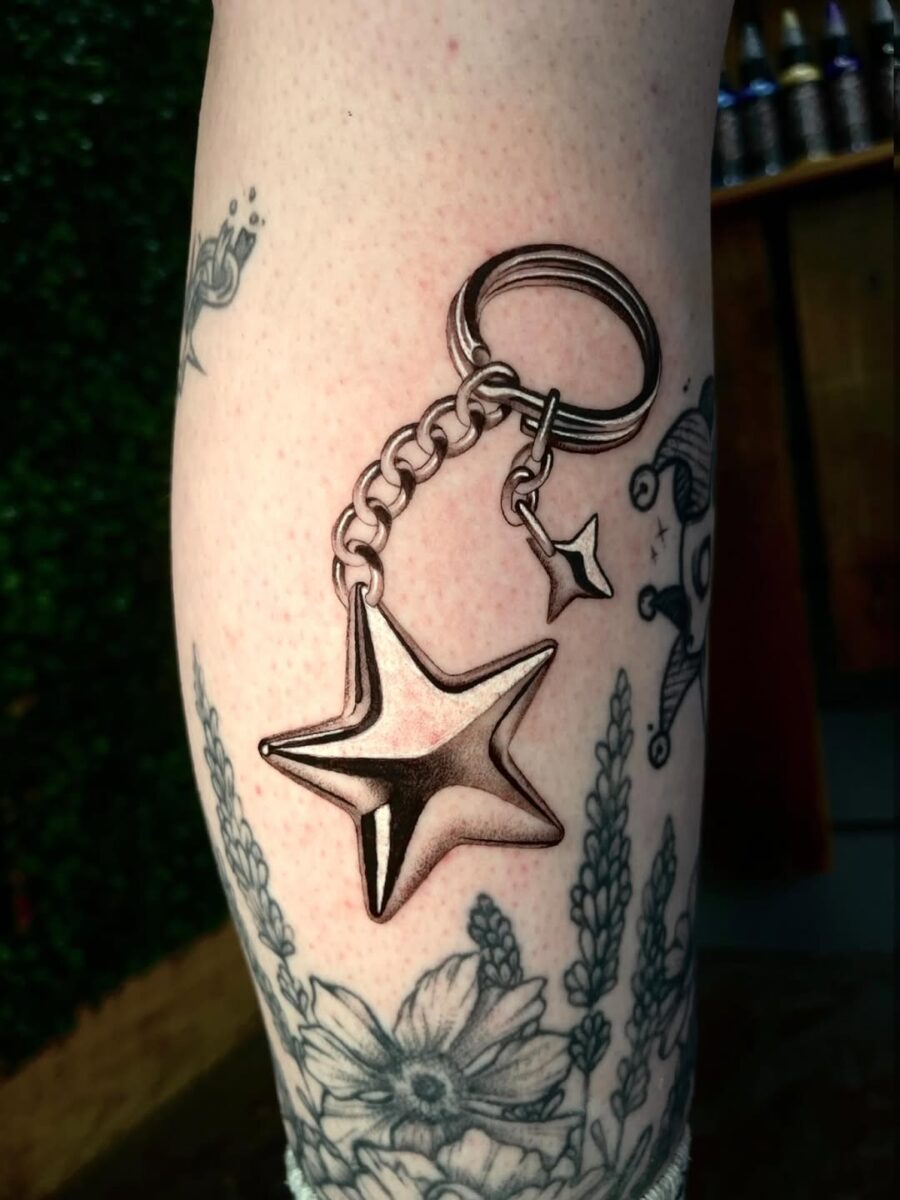 Stylish silver star keychain tattoo design Tattoo on skin