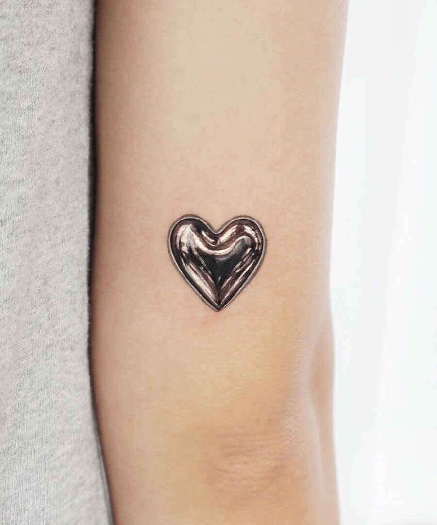 Unique Heart Tattoo in Shiny Silver Ink Tattoo on skin
