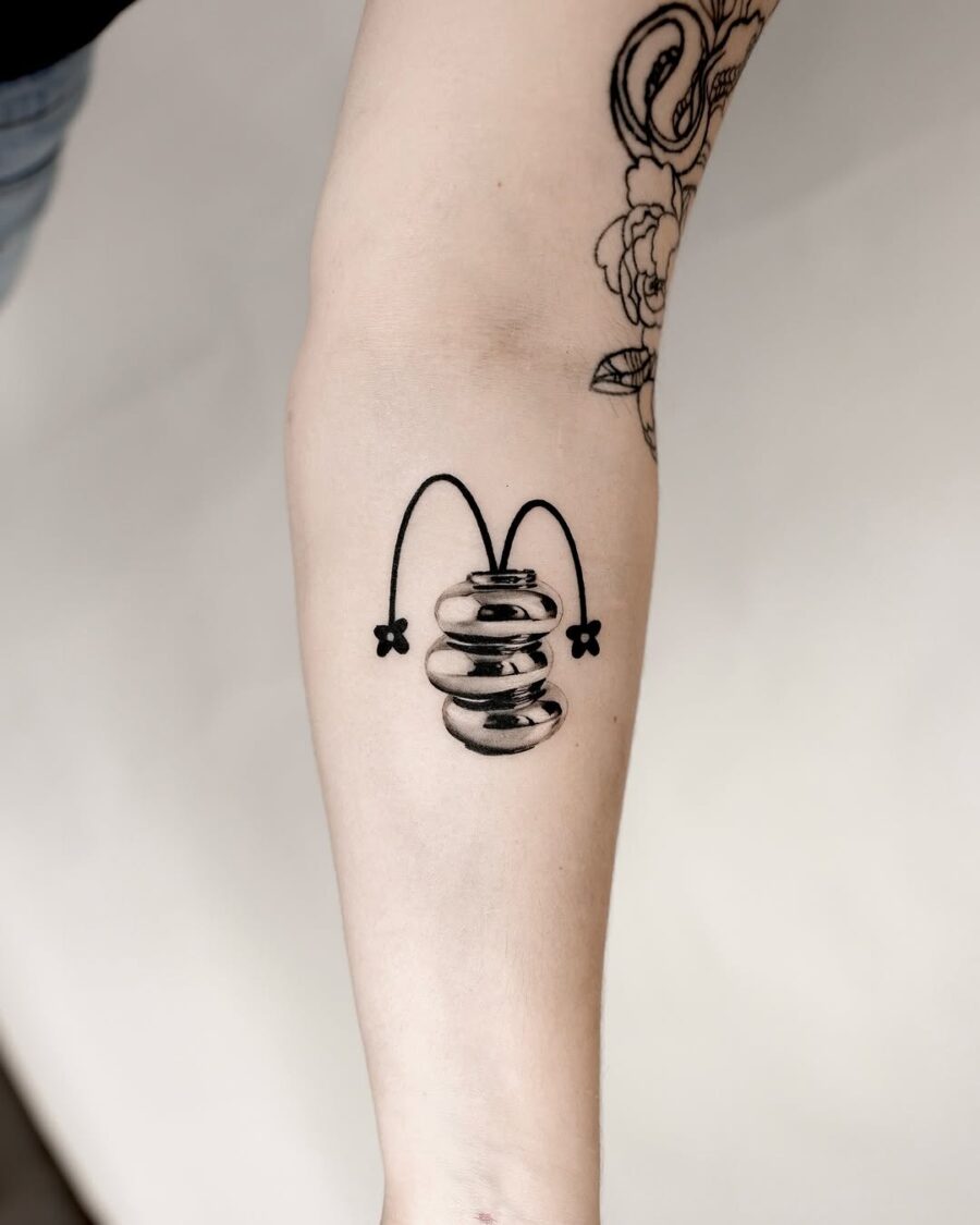 Unique silver ink bouncing design tattoo. Tattoo on skin