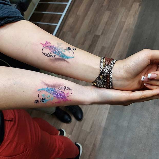 Watercolor Feather Matching Sister Tattoos Tattoo on skin