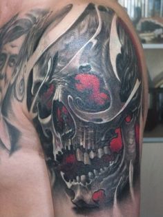 Awesome human skull tattoo on a man’s upper arm Tattoo on skin
