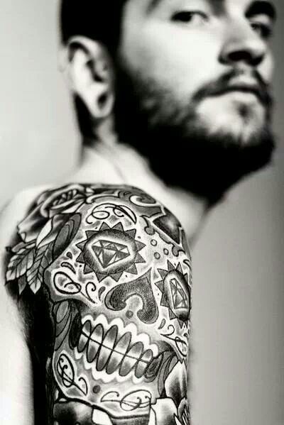 Cool tribal skull tattoo design on a man’s arm Tattoo on skin