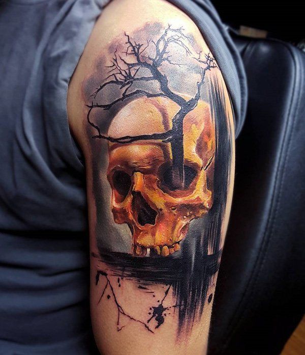 Golden skull and dead tree tattoo on arm Tattoo on skin