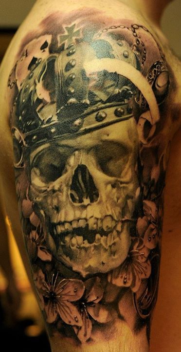 Dark skull tattoo on a guy’s upper arm Tattoo on skin