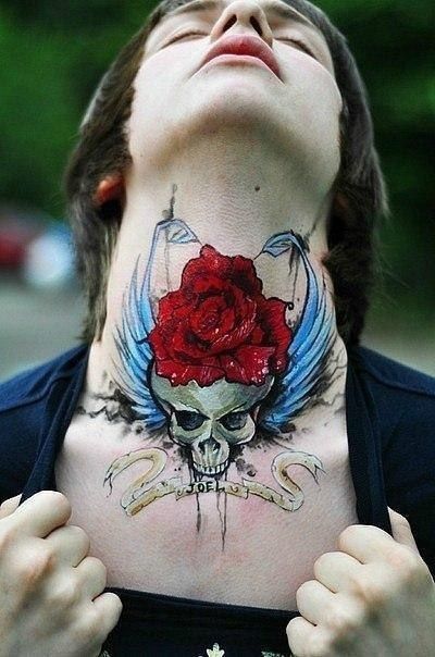 Inscribed sugar skull tattoo with a red rose Tattoo on skin