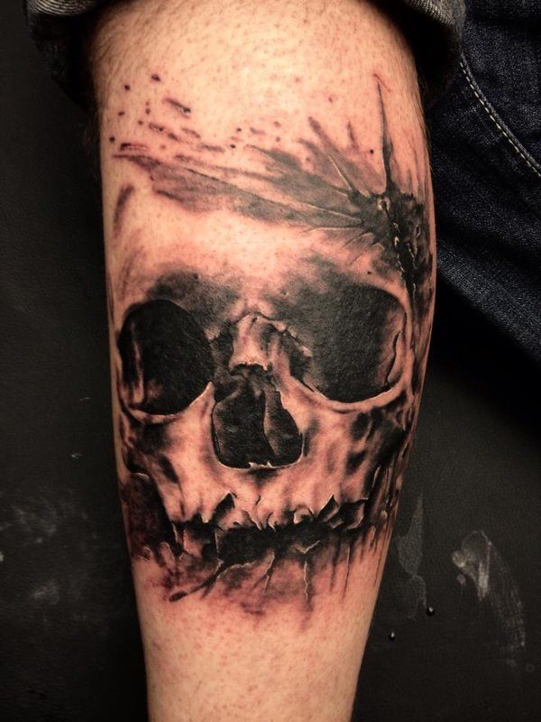 Stamped, dark skull tattoo on leg Tattoo on skin