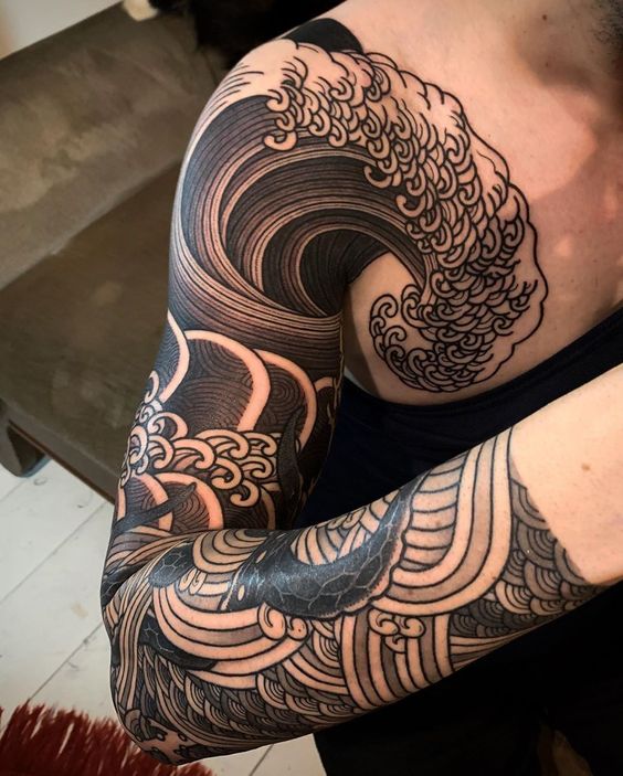 Crashing Wave with Interwoven Sea Serpent Sleeve Tattoo Tattoo on skin