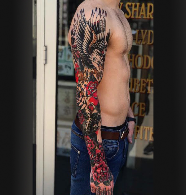 Intricately Drawn Eagle Flower Sleeve Tattoo Tattoo on skin