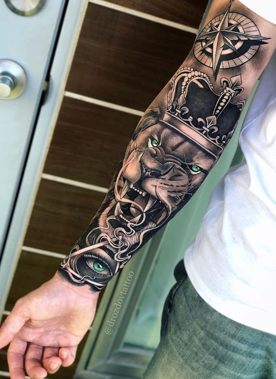 Royal Lion, Compass, and an All-Seeing Eye Sleeve tattoo Tattoo on skin