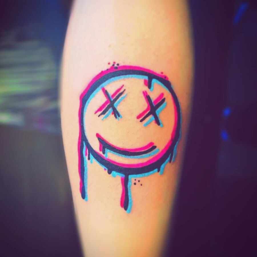 Artistic Smiley Face Tattoo with Drips Tattoo on skin