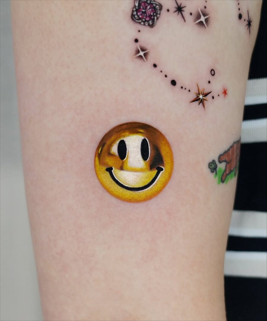 Charming golden smiley face tattoo inspiration Tattoo on skin