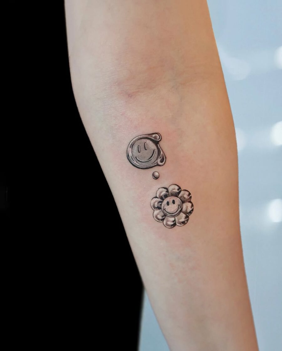 Charming smiley and flower tattoo combination Tattoo on skin