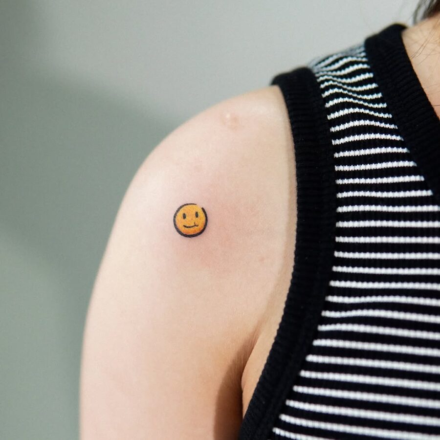 Charming smiley face tattoo on the arm Tattoo on skin