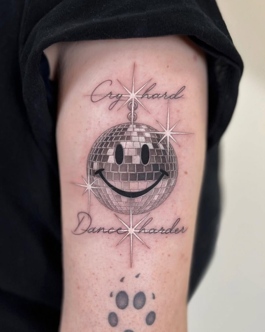 Playful smiley face disco ball tattoo design Tattoo on skin