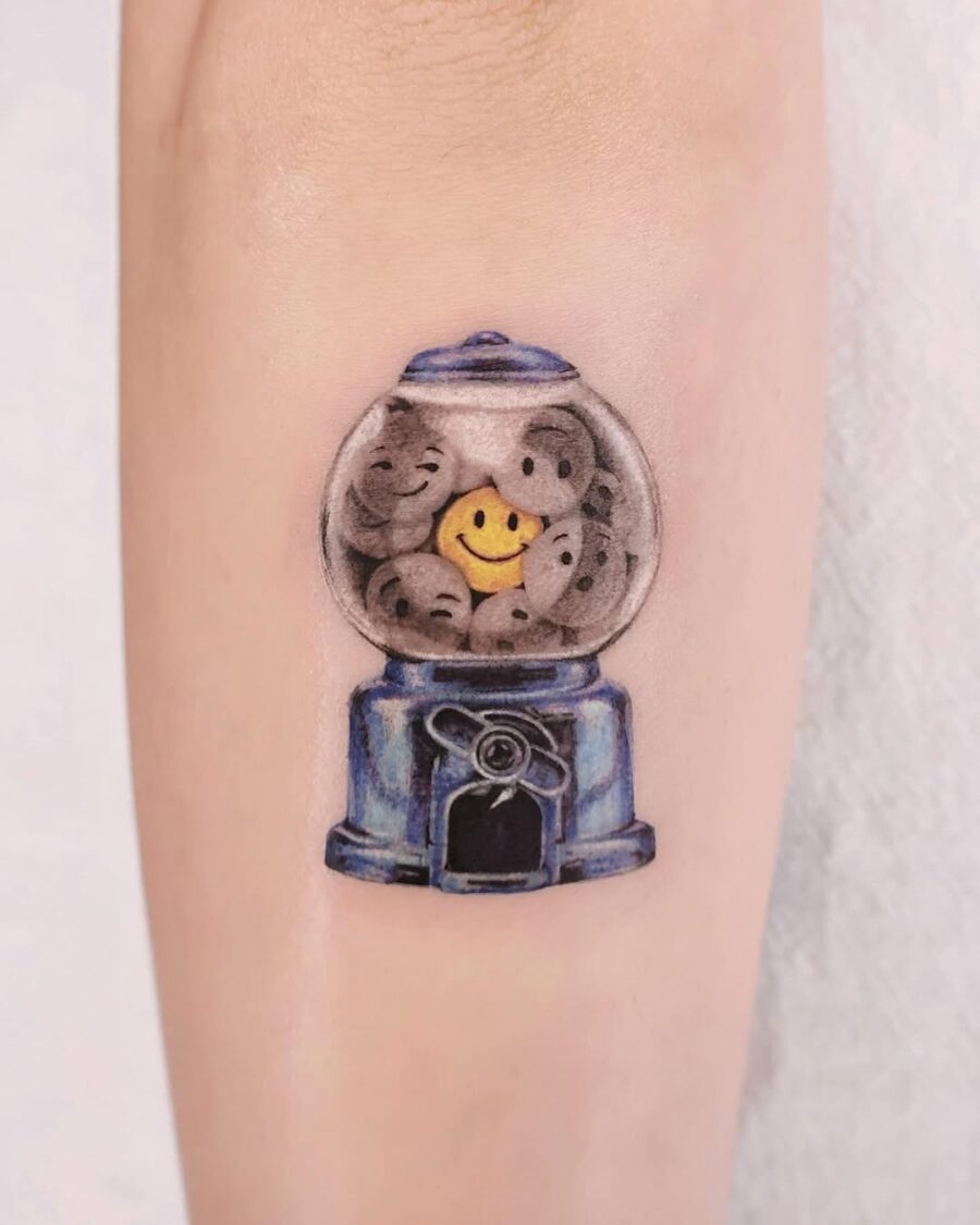 Playful smiley face gumball machine tattoo Tattoo on skin