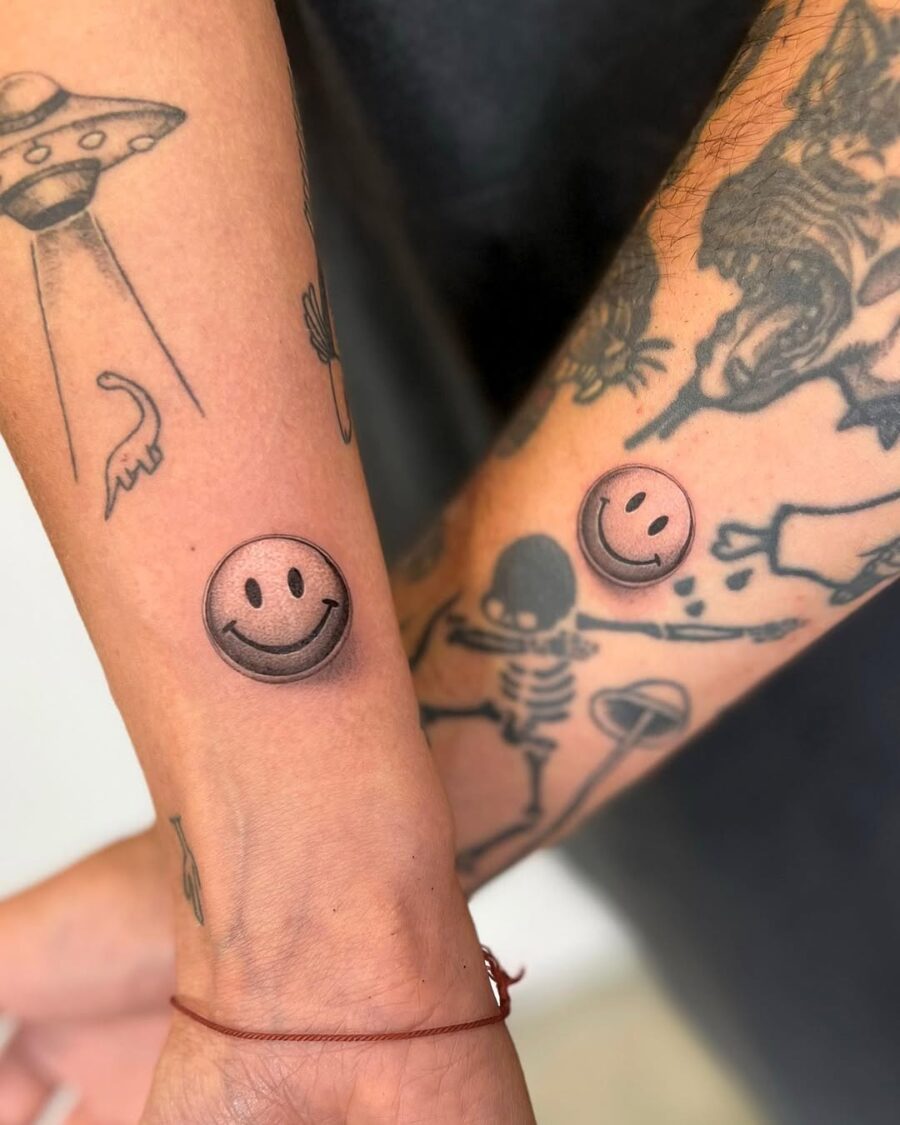 Playful smiley face tattoos on the forearm Tattoo on skin