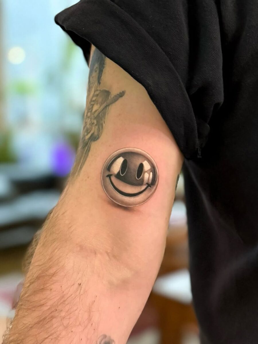 Realistic Smiley Face Tattoo on Arm Tattoo on skin