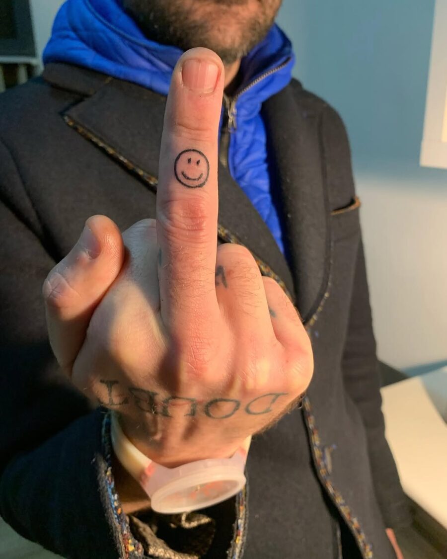 Unique smiley face tattoo on a finger Tattoo on skin