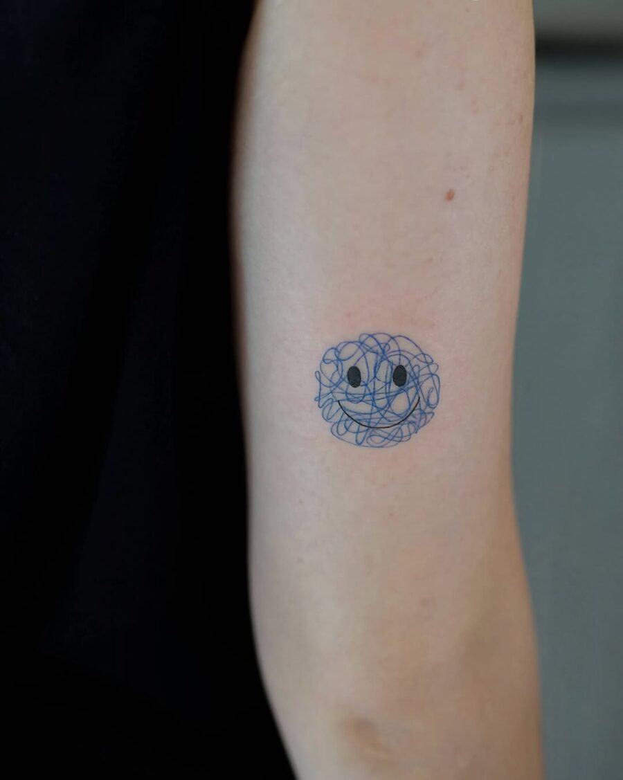 Unique Smiley Face Tattoo with Abstract Swirls Tattoo on skin