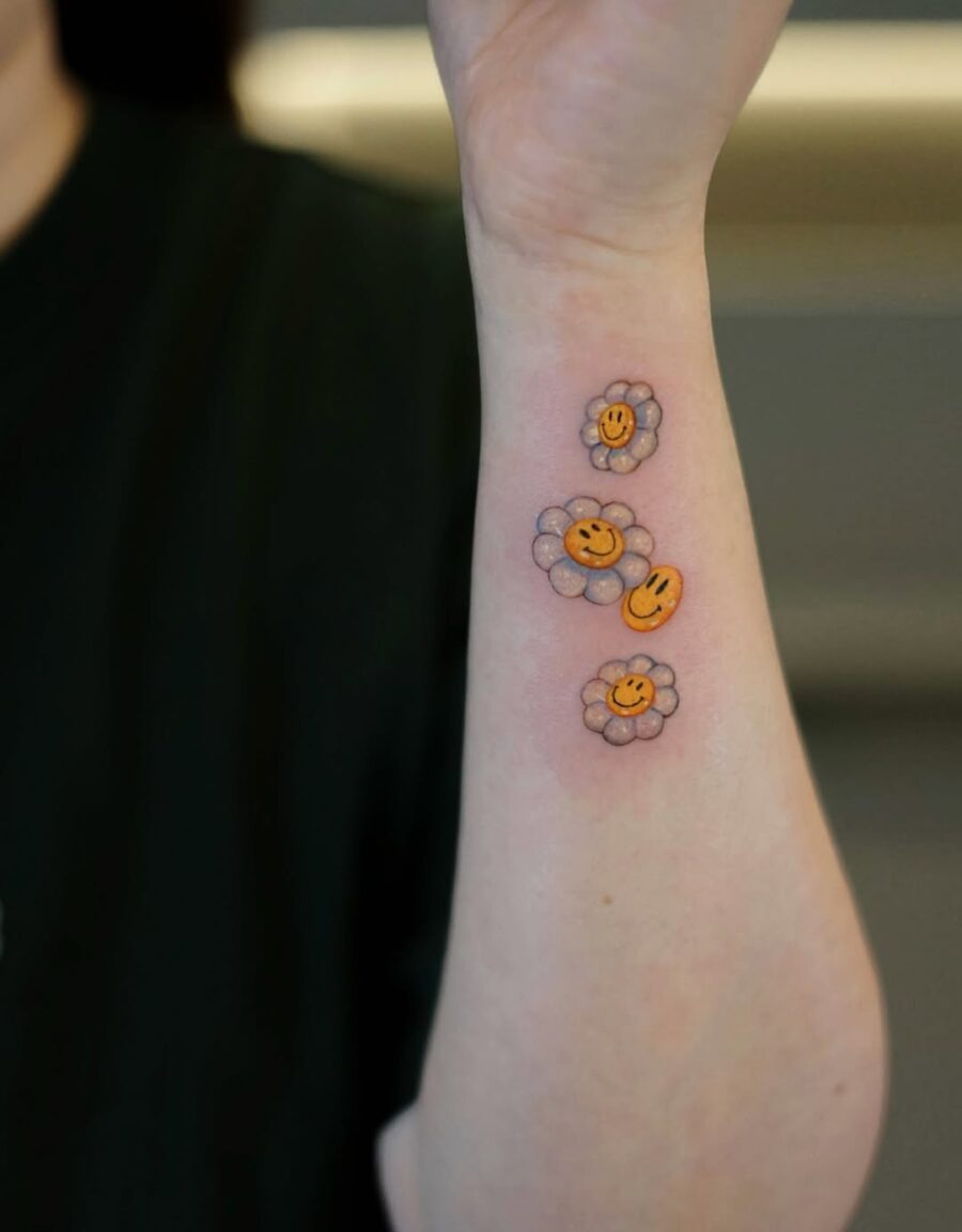 Vibrant smiley flower tattoos for cheerful vibes Tattoo on skin