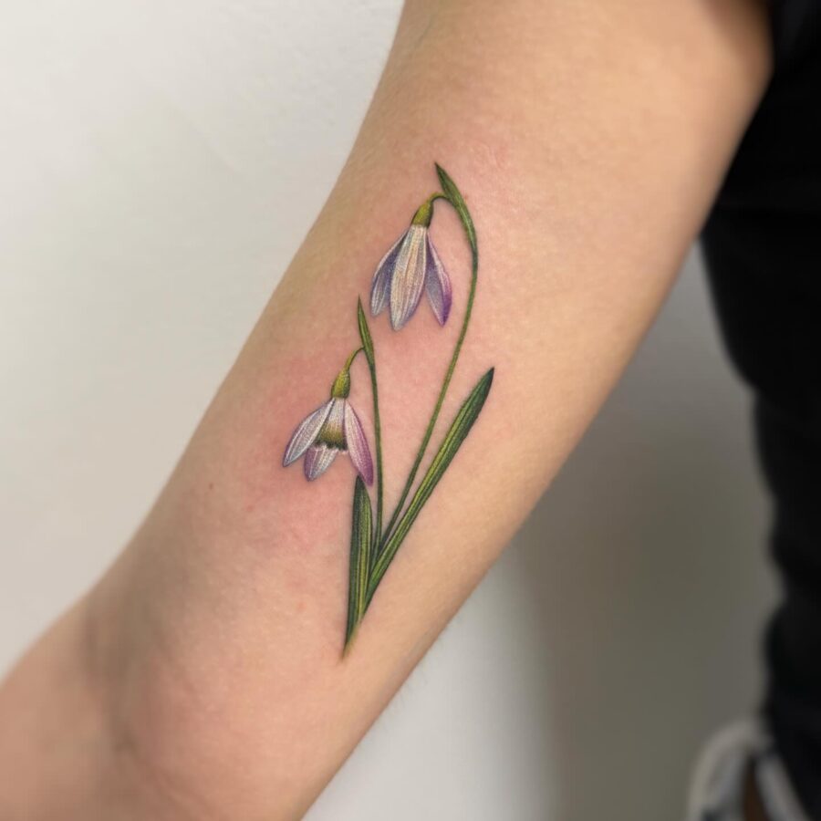 Beautiful snowdrop tattoo with delicate blooms Tattoo on skin