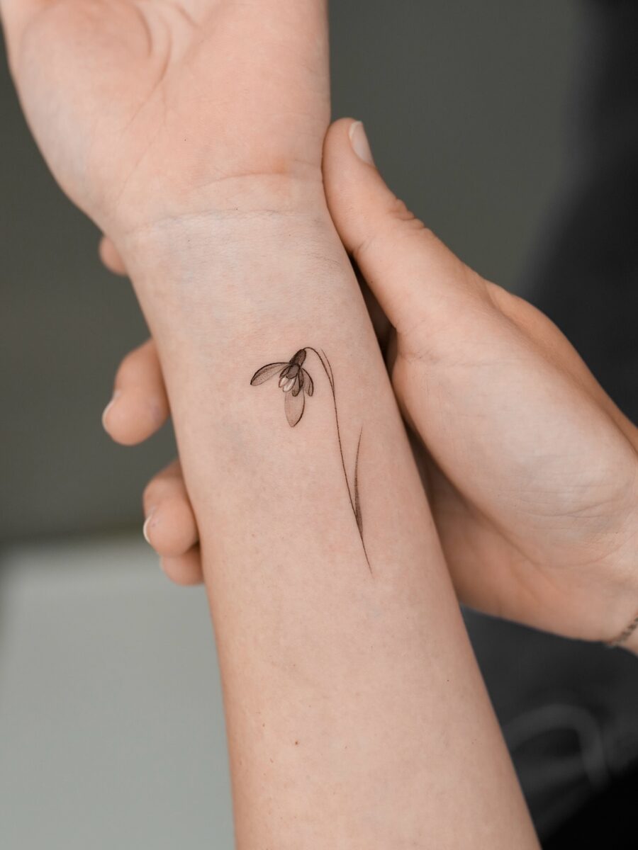 Delicate snowdrop tattoo on the forearm Tattoo on skin