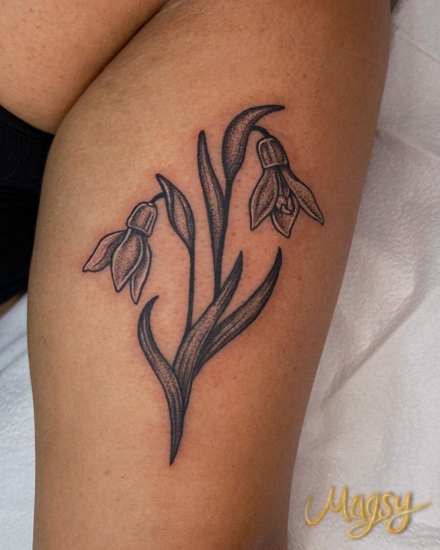 Elegant black and gray snowdrop flower tattoo. Tattoo on skin