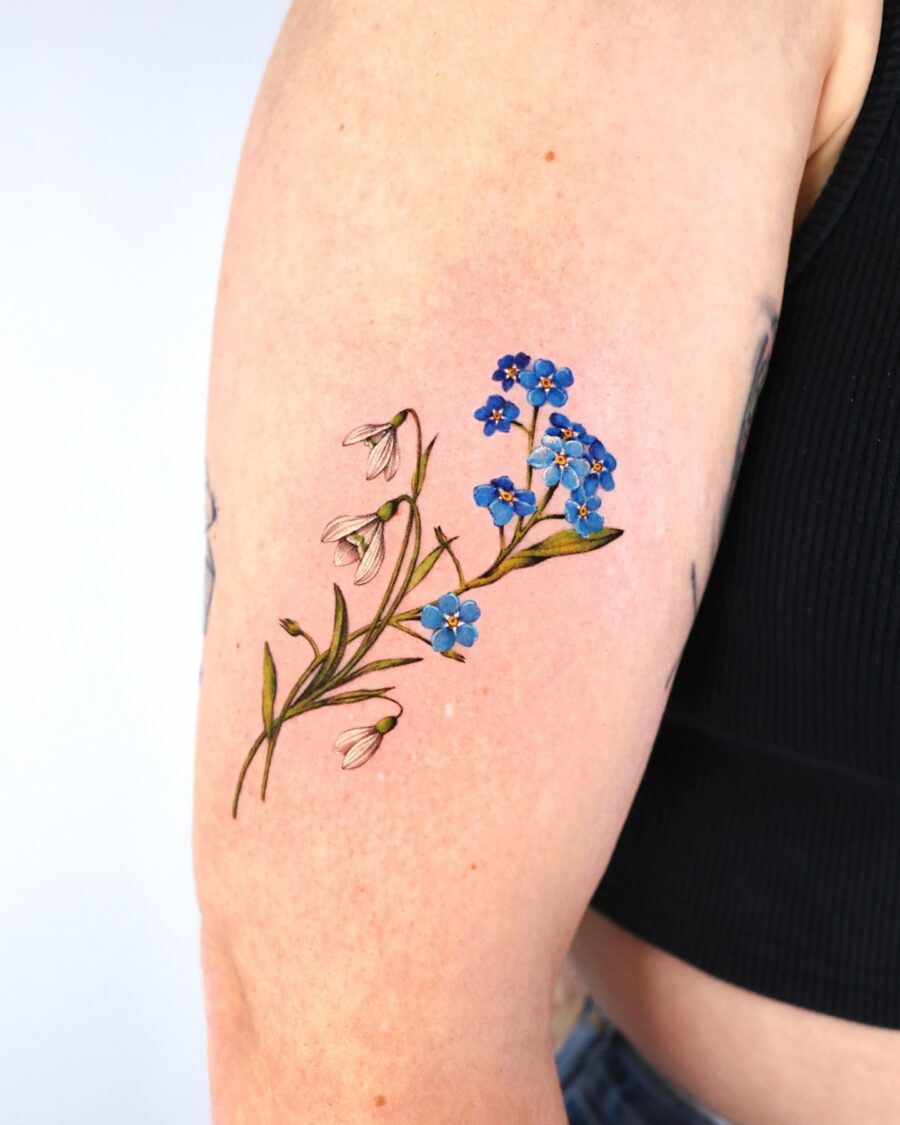 Elegant snowdrop and blue flower tattoo design Tattoo on skin