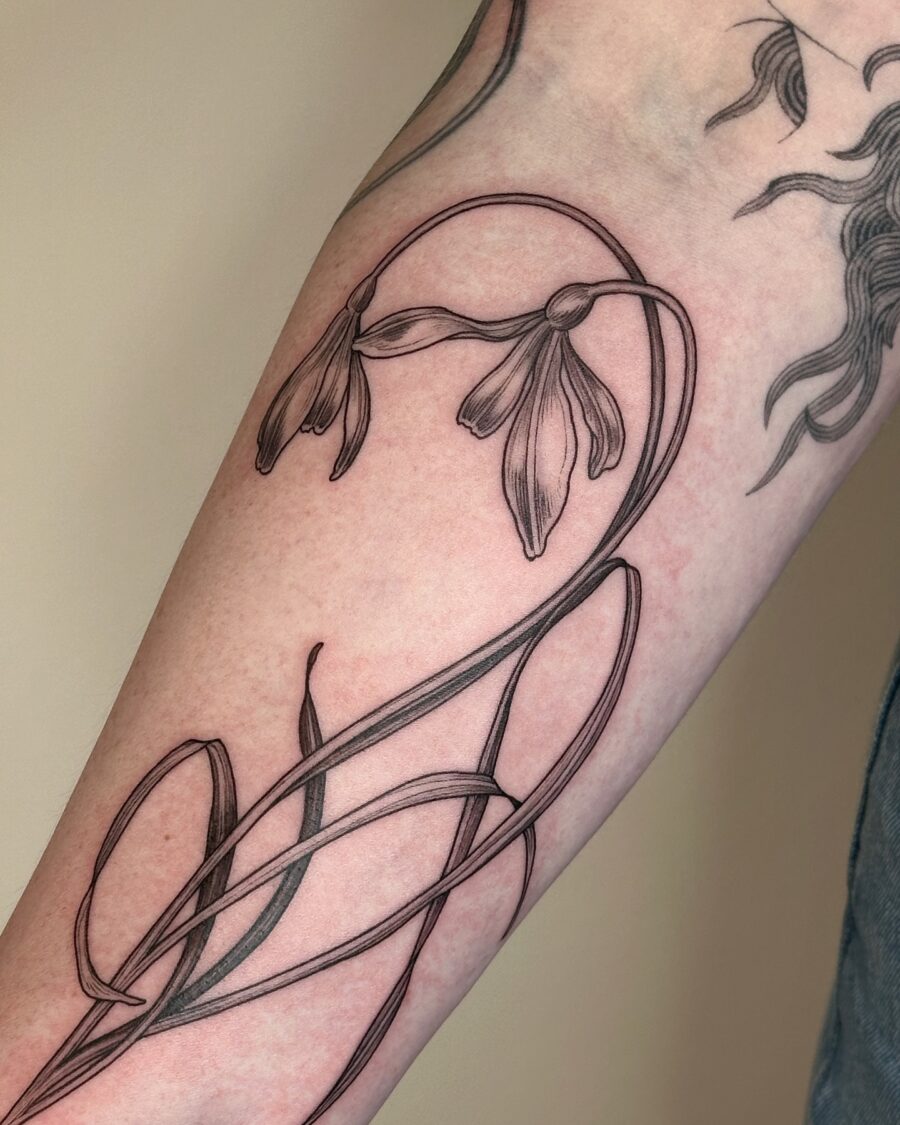 Elegant snowdrop design in minimalist style Tattoo on skin