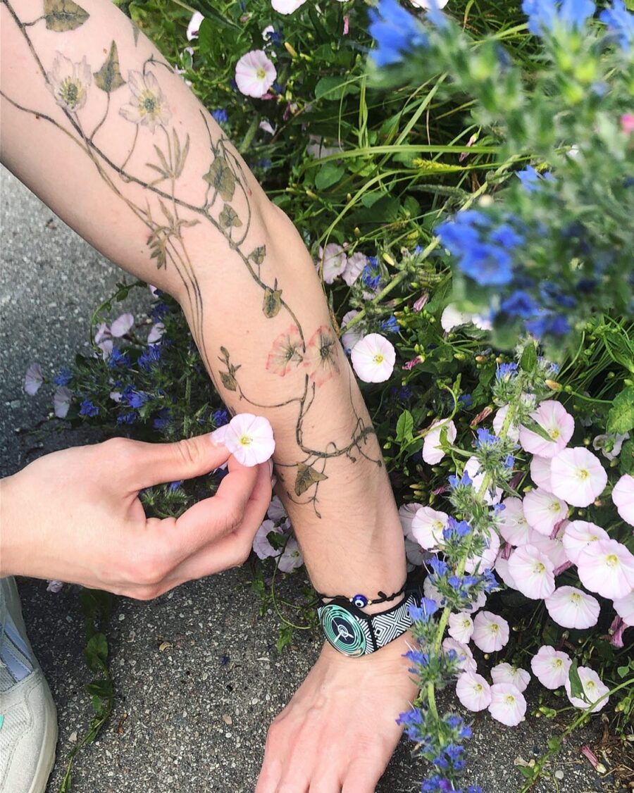 Elegant snowdrop design wrapped around the arm Tattoo on skin