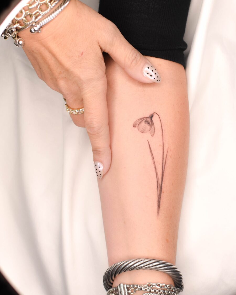 Elegant snowdrop flower tattoo on forearm Tattoo on skin