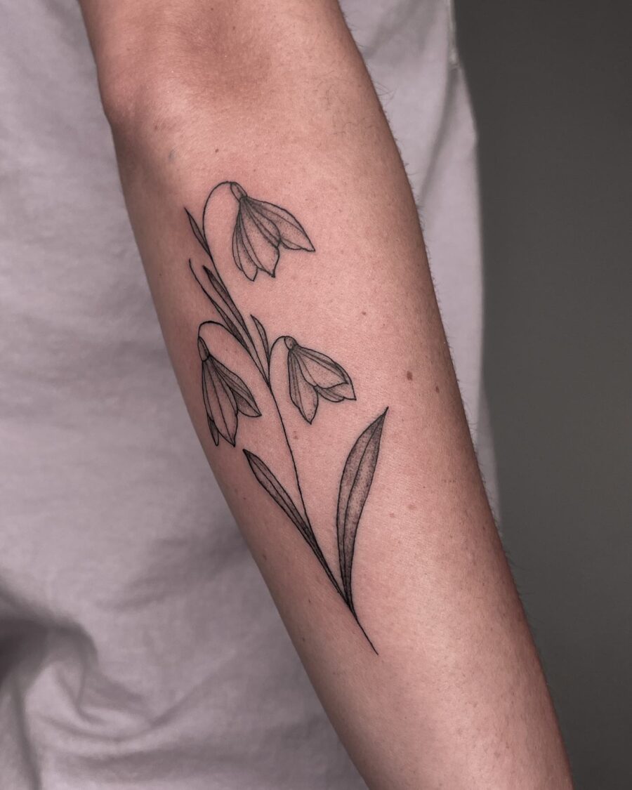 Elegant snowdrop flower tattoo on forearm Tattoo on skin