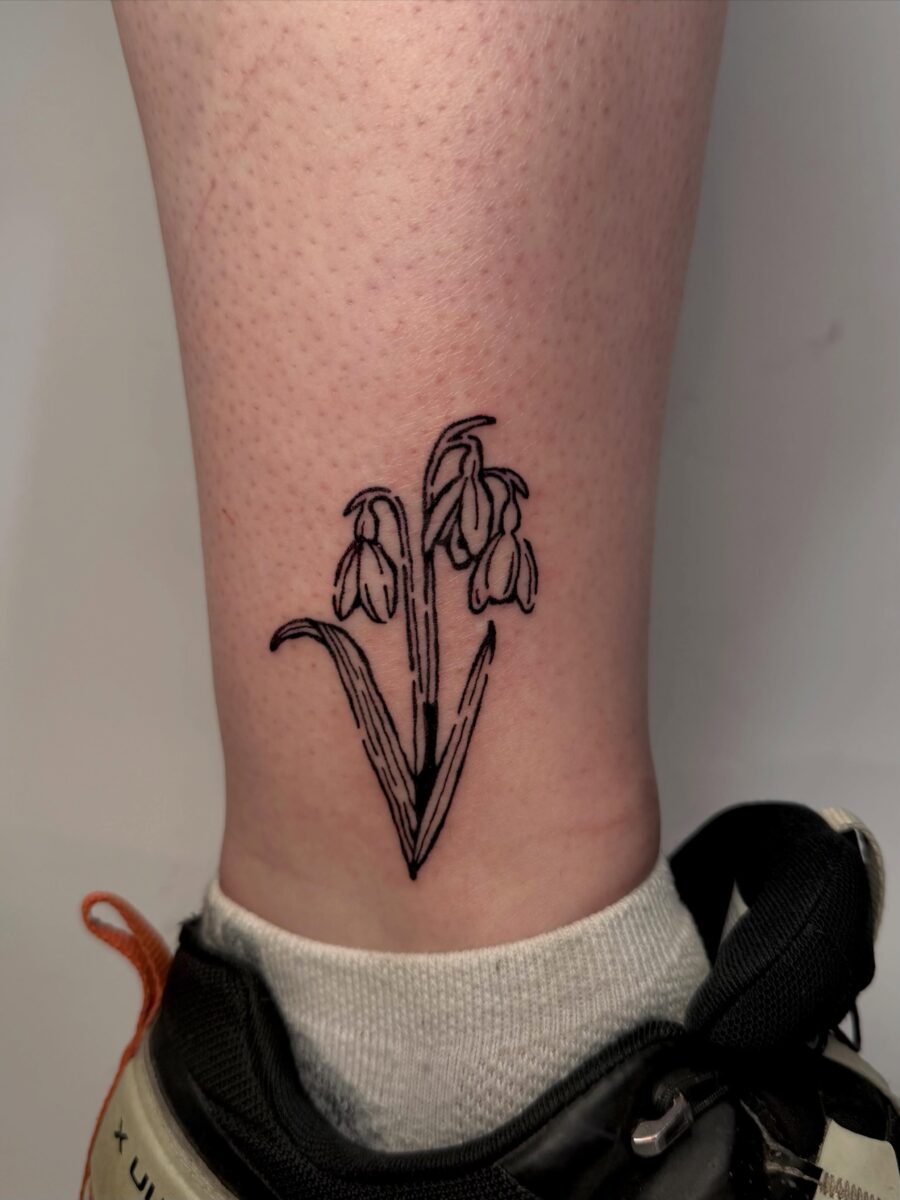 Elegant snowdrop flower tattoo on the ankle Tattoo on skin