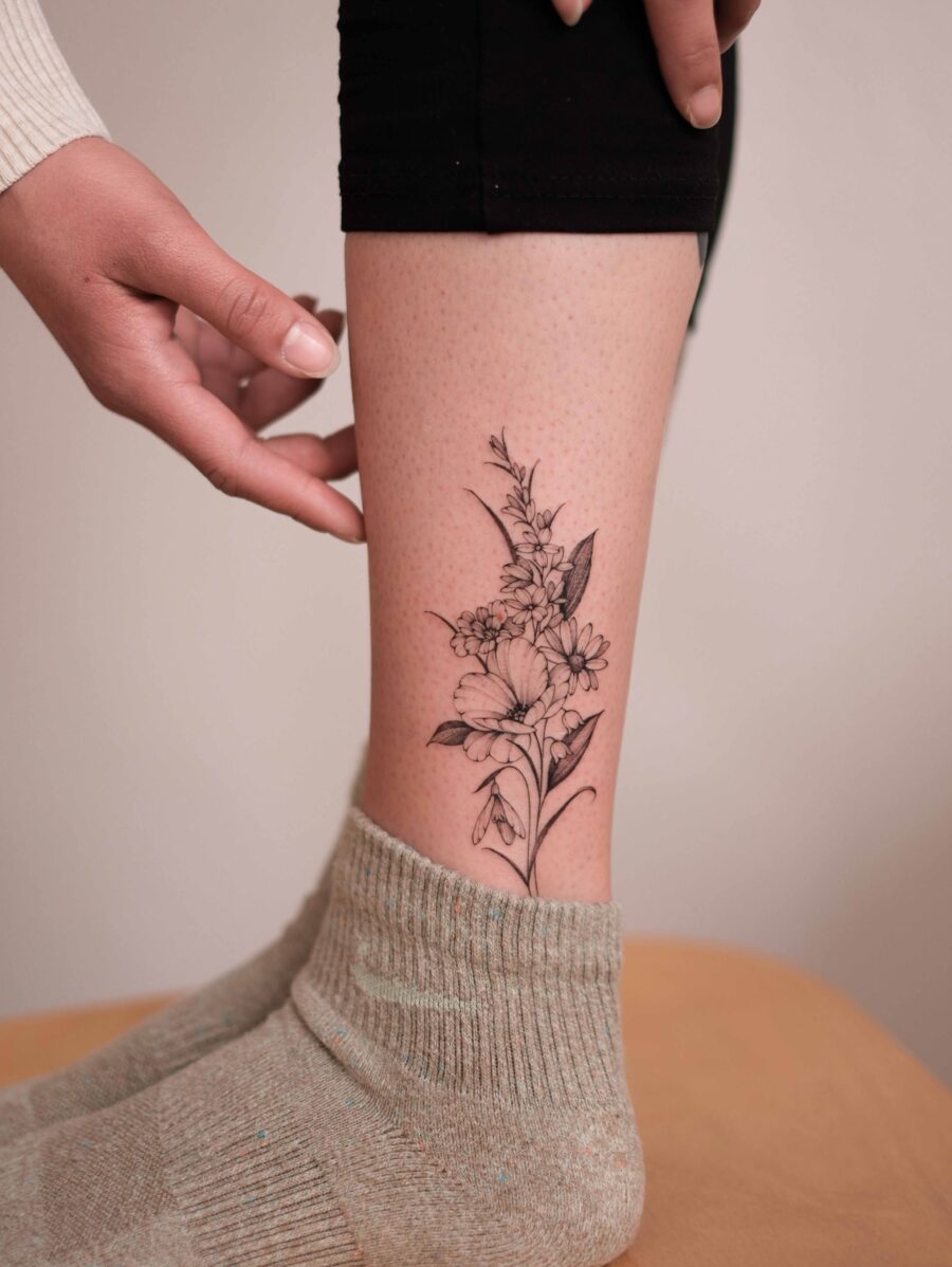 Elegant snowdrop flower tattoo on the leg Tattoo on skin