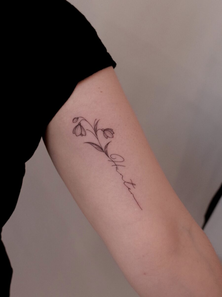 Elegant snowdrop tattoo embracing natural beauty Tattoo on skin