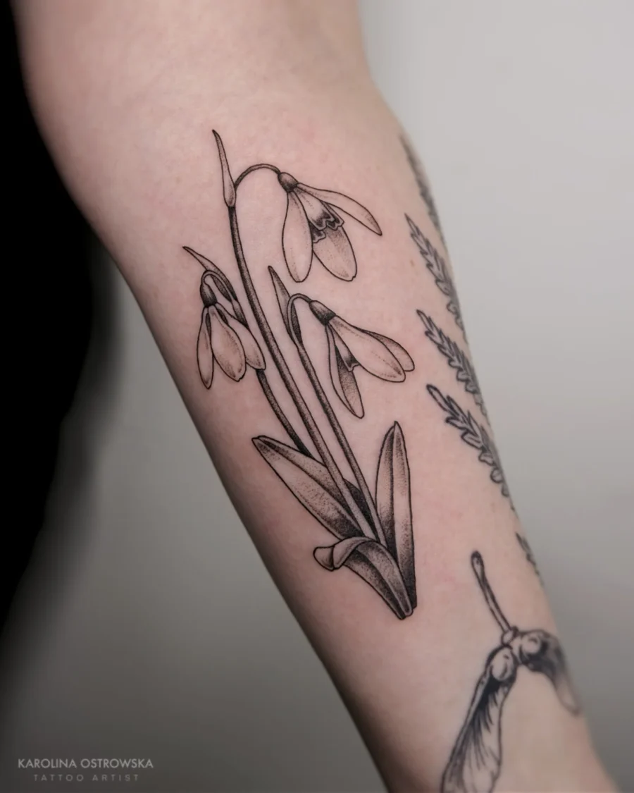 Elegant Snowdrop Tattoo in Black Ink Tattoo on skin