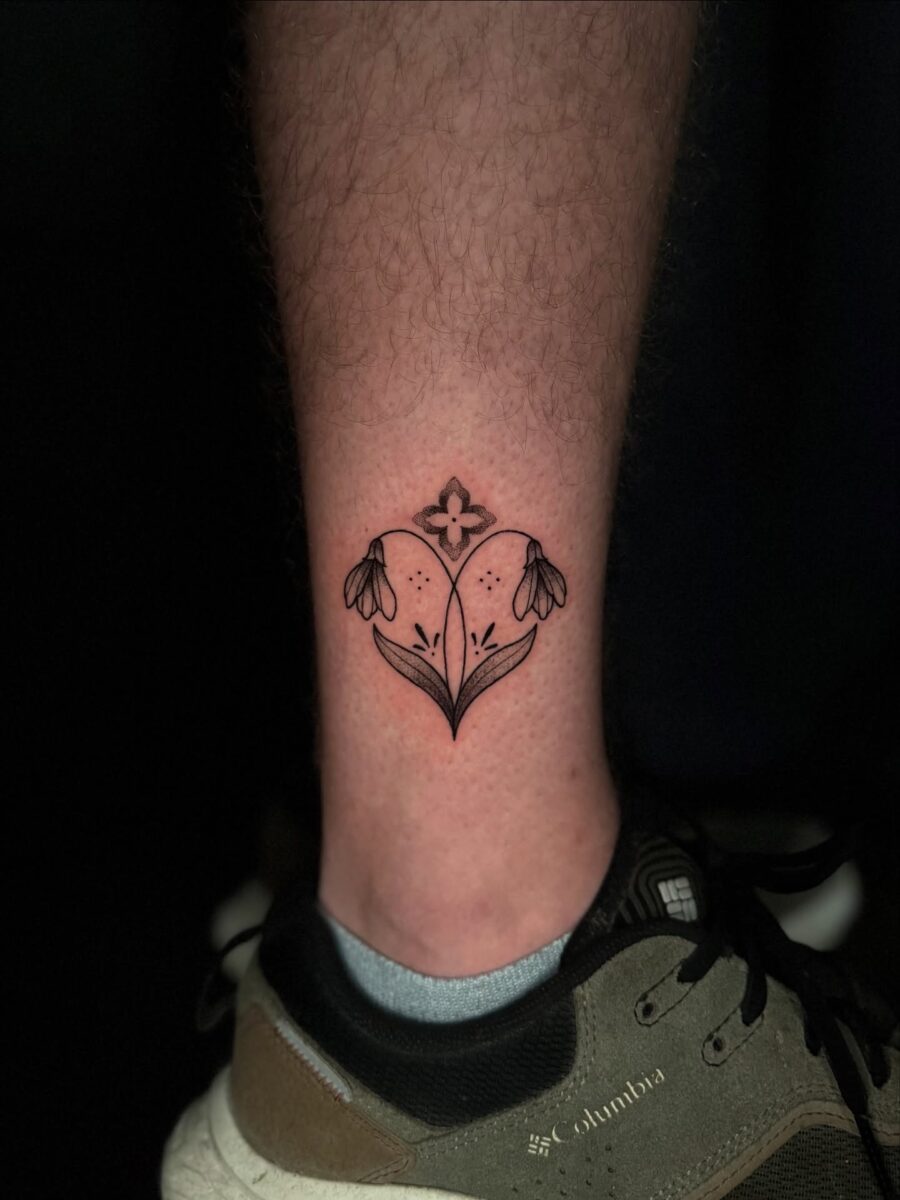 Elegant snowdrop tattoo on a leg Tattoo on skin